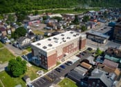 Thumbnail 4 of 36 - arial view of a brick building with a white roof