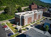 Thumbnail 10 of 41 - a large brick building with a white roof