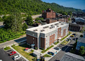 Thumbnail 9 of 41 - a view from above of a large brick building with a white roof and a red brick building