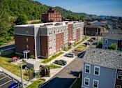 Thumbnail 8 of 41 - an aerial view of an apartment complex with a mountain in the background