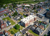 Thumbnail 2 of 36 - arial view of a small town with a large building in the middle