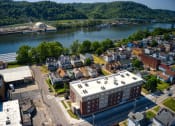 Thumbnail 6 of 36 - arial view of a small town with a river in the background