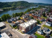 Thumbnail 8 of 36 - an aerial view of a small town with a river in the background
