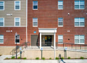 Thumbnail 3 of 36 - a large brick building with a staircase in front of it
