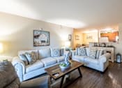 Thumbnail 5 of 55 - A living room with a grey couch and a coffee table.