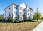 Thumbnail 43 of 55 - A large white apartment building with a red heart on the front.