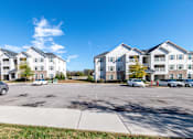 Thumbnail 50 of 55 - A sunny day at a parking lot in front of apartment buildings.