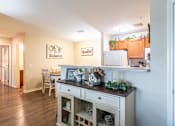 Thumbnail 8 of 55 - A kitchen with a white refrigerator and wooden cabinets.