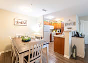 Thumbnail 10 of 55 - A kitchen with a dining table and chairs in front of a wall with a sign that says Thankful.