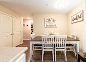 Thumbnail 11 of 55 - A dining room with a table set for two and a sign on the wall that says "thankful".