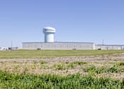 Thumbnail 21 of 27 - a water tower in the middle of a field