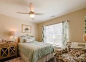 Thumbnail 10 of 27 - a bedroom with a bed and a chair