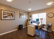 Thumbnail 9 of 27 - an office with a desk and two chairs and a clock on the wall