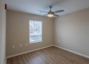 Thumbnail 6 of 32 - A room with a ceiling fan and a window.