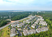 Thumbnail 36 of 37 - A bird's eye view of a residential area with houses and greenery.