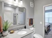 Thumbnail 14 of 25 - a bathroom with a mirror and a toilet and a sink