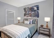 Thumbnail 7 of 25 - a bedroom with a bed and a painting on the wall