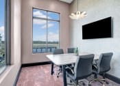 Thumbnail 24 of 25 - a conference room with a table and chairs and a window