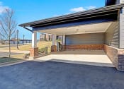 Thumbnail 19 of 25 - the garage of a home with a covered porch