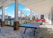 Thumbnail 20 of 25 - enjoy a game of ping pong on our covered patio