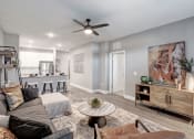 Thumbnail 4 of 25 - a living room with a couch and a ceiling fan