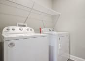 Thumbnail 12 of 28 - laundry room has full size washer and dryer with shelving behind it