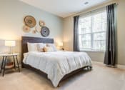 Thumbnail 7 of 23 - a bedroom with a large bed in front of a window