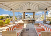 Thumbnail 21 of 28 - a patio with couches and chairs and tables
