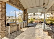 Thumbnail 24 of 28 - the outdoor kitchen has stainless steel appliances and a grill