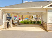 Thumbnail 23 of 28 - the entrance of a car garage with a driveway to a house