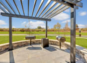 Thumbnail 28 of 28 - a patio with awnings and two hot tubs in a park