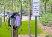 Thumbnail 21 of 23 - a purple electric vehicle charging station with a sign in the background