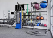 Thumbnail 18 of 23 - a view of the fitness center with weights and other exercise equipment