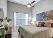 Thumbnail 9 of 25 - a bedroom with a bed and a ceiling fan