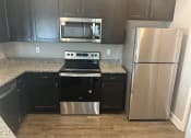 Thumbnail 9 of 21 - Kitchen with stainless steel appliances at Ascent at Mallard Creek Apartment Homes, Charlotte, NC