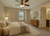 Thumbnail 10 of 16 - A bedroom with a large bed and a ceiling fan.