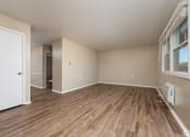 Thumbnail 4 of 18 - an empty living room with wood flooring and a window