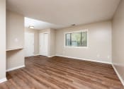 Thumbnail 7 of 18 - an empty living room with wood flooring and a window