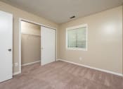 Thumbnail 10 of 18 - an empty bedroom with a closet and a window