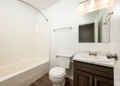 Thumbnail 6 of 18 - a bathroom with a sink toilet and a bath tub