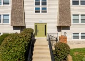 Thumbnail 18 of 18 - the front of a white house with a green door