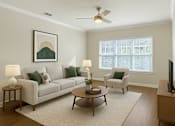 Thumbnail 2 of 15 - A living room with a white couch, a coffee table, and a painting on the wall.