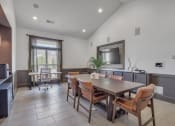 Thumbnail 11 of 34 - a dining room with a wooden table and chairs