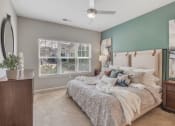 Thumbnail 18 of 34 - a bedroom with a bed and a ceiling fan