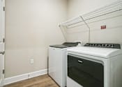 Thumbnail 20 of 25 - A white oven and microwave are sitting on a shelf in a kitchen.