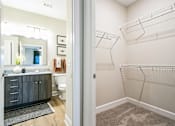 Thumbnail 21 of 25 - A bathroom with a walk-in closet.
