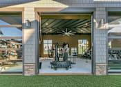 Thumbnail 10 of 25 - A modern house with a garage and a gym inside.