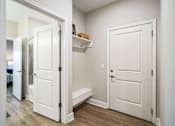 Thumbnail 23 of 25 - A white door is open to a hallway.