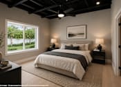 Thumbnail 2 of 16 - A bedroom with a large bed and a ceiling fan.