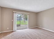Thumbnail 11 of 24 - Unfurnished carpeted bedroom with sliding doors to a screened patio at Waterchase Apartments in Largo, FL.